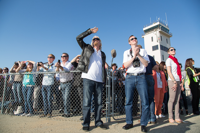 Richard Branson and Virgin Galactic CEO George Whitesides along with other VIPs and employees watching the first powered flight of SpaceShipTwo over the Mojave Desert.